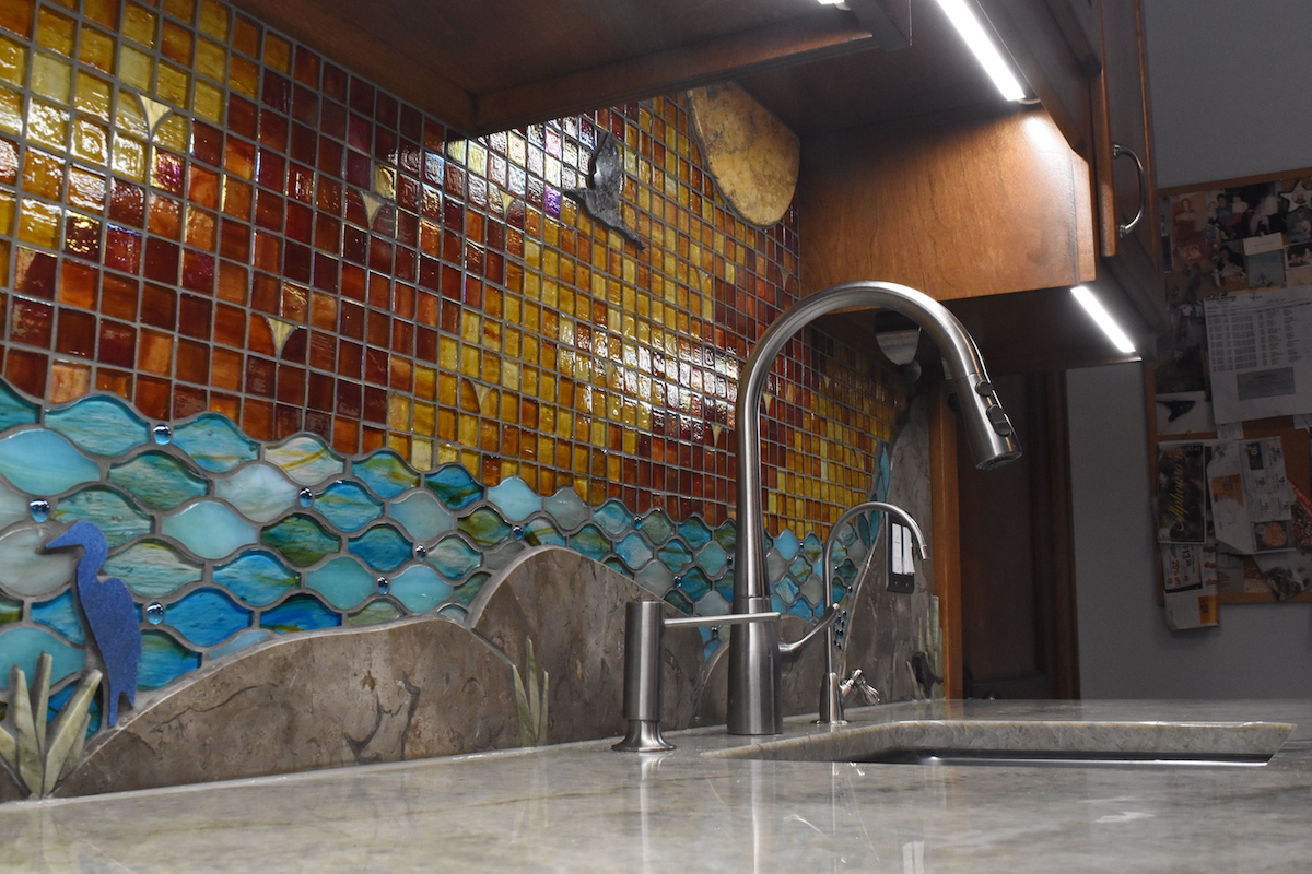 Custom mosaic artistic glass and stone backsplash