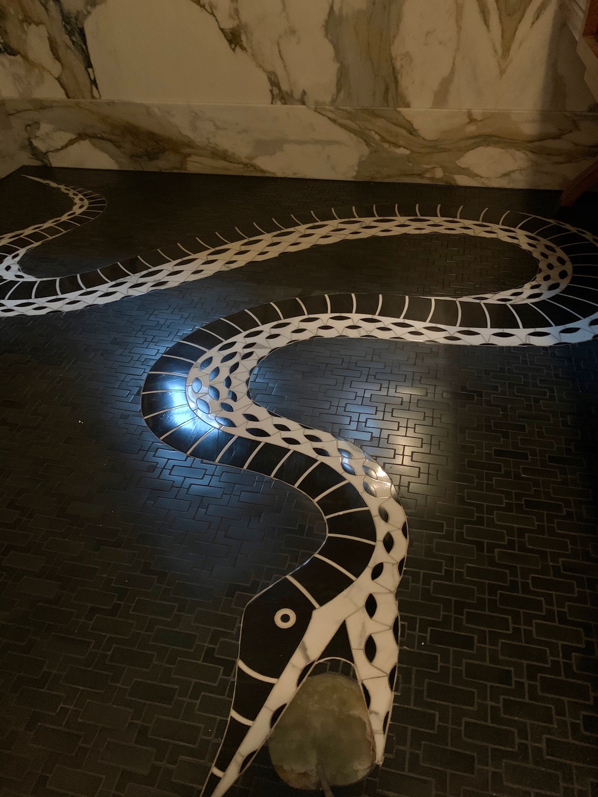 dramatic custom marble mosaic inspired by artist Fornasetti, serpent marble mosaic powder room floori