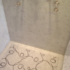 Waterworks Carrara Marble shower with carrara marble mosaic floor