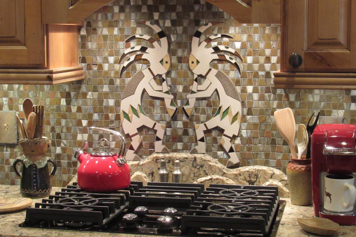 Custom kokopelli stone and tile backsplash